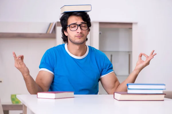 Young handsome student studying at home — Stock Photo, Image