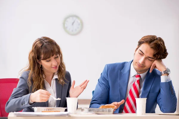Two colleagues having lunch break at workplace Royalty Free Stock Images