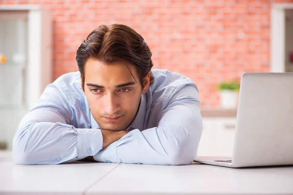 Young handsome employee working in the office — Stock Photo, Image