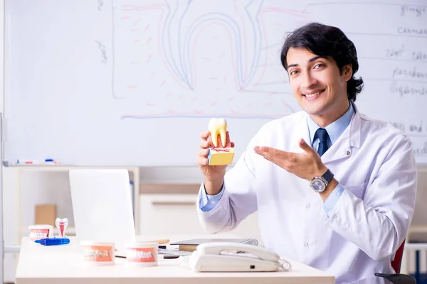 Young handsome dentist in front of the whiteboard — Stock Photo, Image