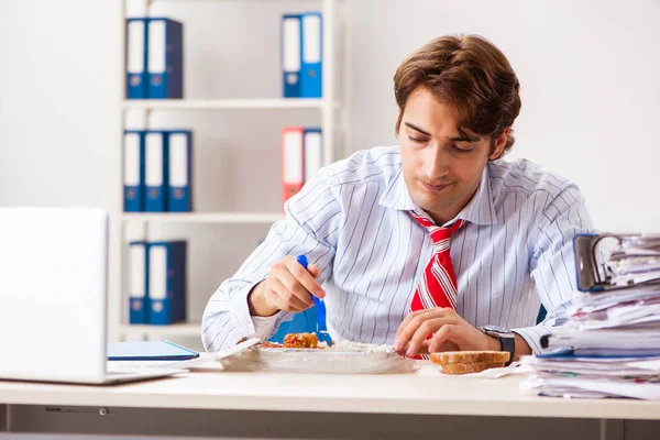 Man having meal at work during break