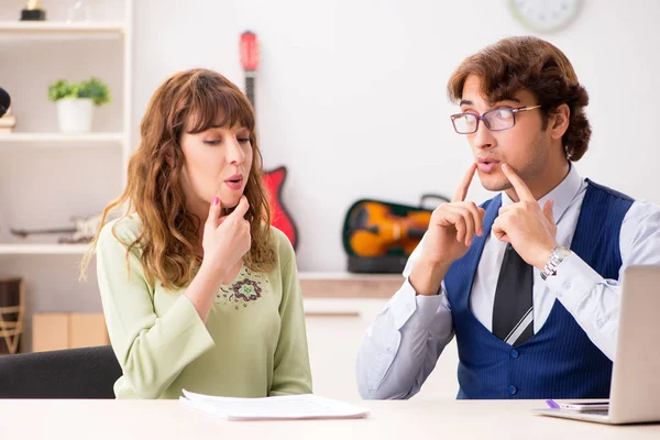 Young woman during music lesson with male teacher — Stock Photo, Image