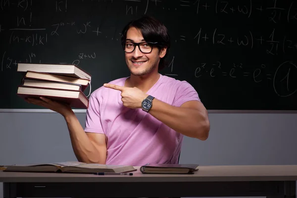 Young male student sitting in classroom — Stock Photo, Image