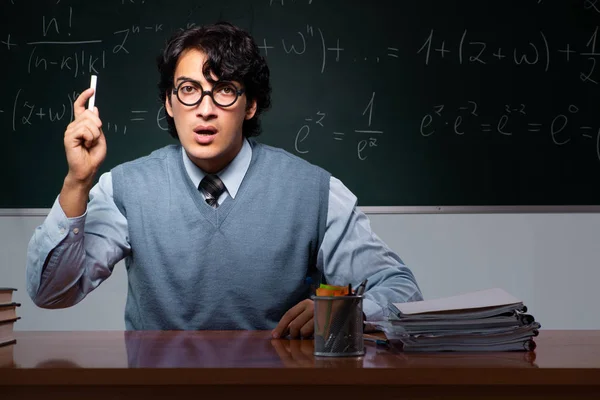 Young math teacher in front of chalkboard — Stock Photo, Image