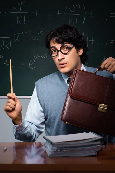 Young math teacher in front of chalkboard — Stock Photo, Image