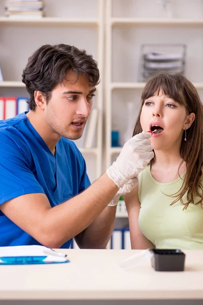 Doctor getting saliva test sample in clinic hospital — Stock Photo, Image