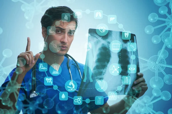 Young doctor looking at x-ray image in mhealth concept — Stock Photo, Image