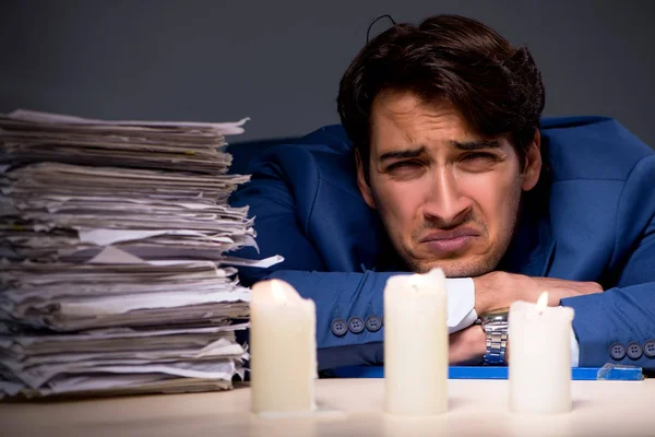 Businessman working late in office with candle light — Stock Photo, Image