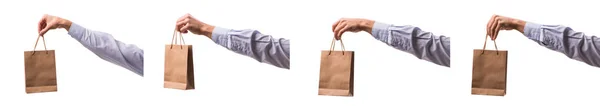 Hand holding shopping bags with christmas shopping on white back — Stock Photo, Image