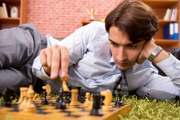 Young handsome boss playing chess during break — Stock Photo, Image