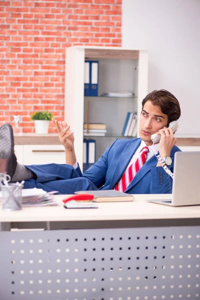 Young handsome employee working in the office — Stock Photo, Image