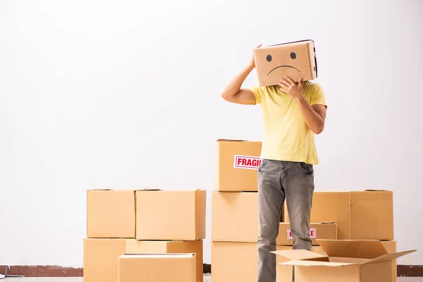 Unhappy man with box instead of his head