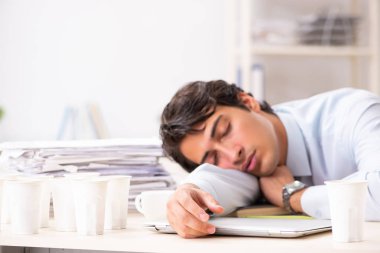 Kahve bağımlısı genç bir çalışan.