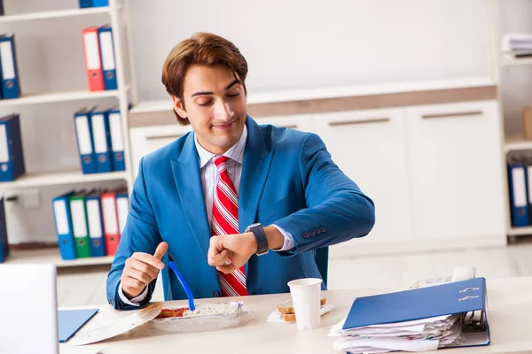 Man having meal at work during break