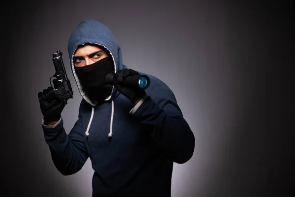 Junger Gangster mit Kapuze auf grauem Hintergrund — Stockfoto