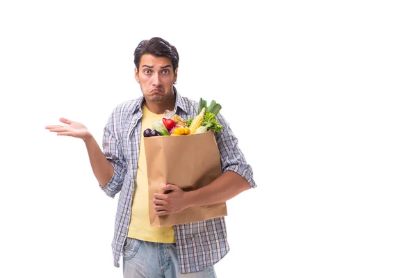 Mladý muž se svým nákupem potravin na bílém — Stock fotografie