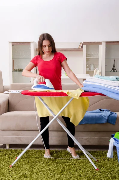 Young beautiful woman ironing at home — Stock Photo, Image