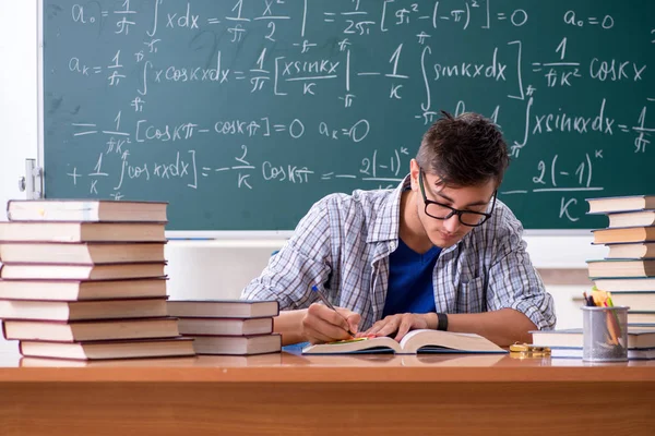 Jonge mannelijke student studeert wiskunde op school — Stockfoto