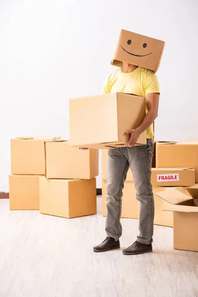 Happy man with box instead of his head