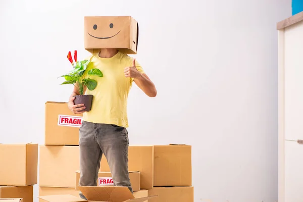 Happy man with box instead of his head