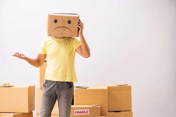 Unhappy man with box instead of his head