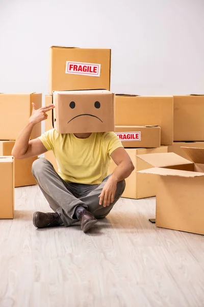 Unhappy man with box instead of his head