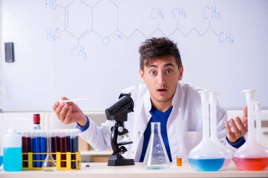 Laboratuarda oturan genç kimyager 