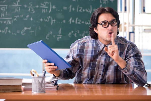 Молодий смішний вчитель математики перед дошкою — стокове фото
