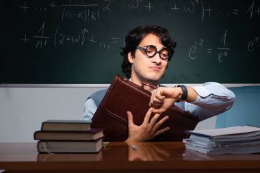 Kara tahta önünde genç matematik öğretmeni