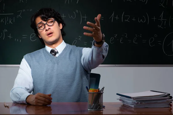 Jovem professor de matemática na frente do quadro — Fotografia de Stock