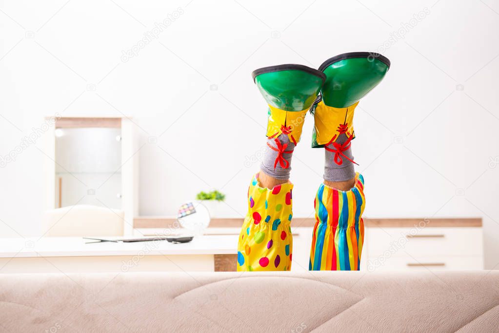 Male clown preparing for perfomance at home 