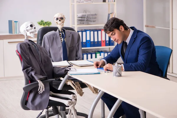 Funny business meeting with boss and skeletons — Stock Photo, Image