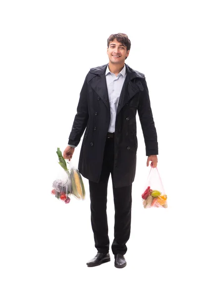 Joven hombre guapo con verduras en concepto de compras — Foto de Stock