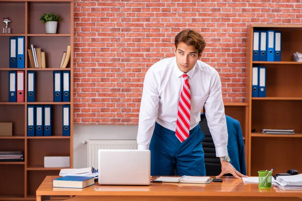 Young handsome employee sitting in the office — Stock Photo, Image