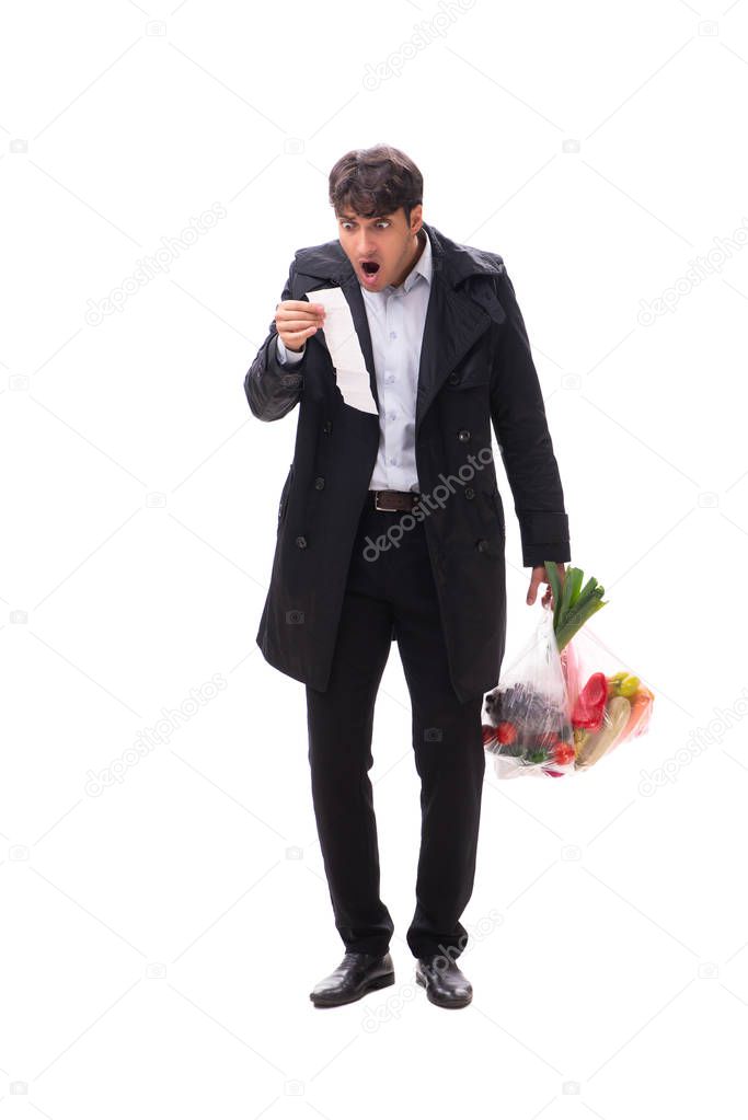 Young handsome man with vegatables in shopping concept 