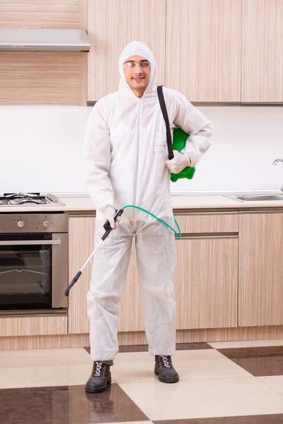 Professional contractor doing pest control at kitchen — Stock Photo, Image