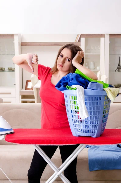 Young beautiful woman ironing at home — Stock Photo, Image