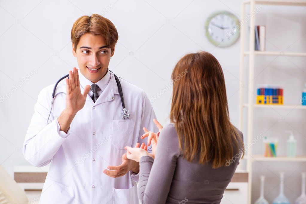 Deaf-mute female patient visiting young male doctor 