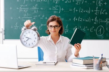 Kara tahta önünde kadın matematik öğretmeni 