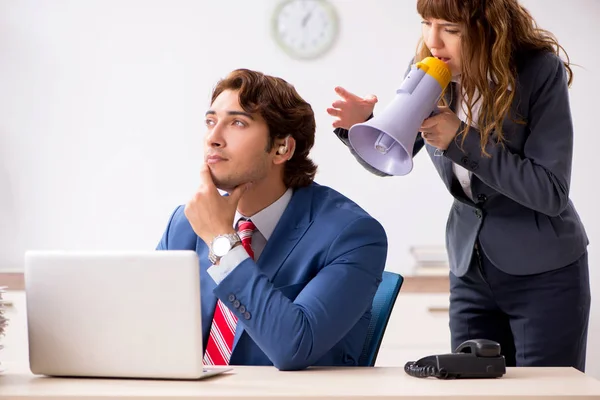 Deaf employee using hearing aid talking to boss — Stock Photo, Image