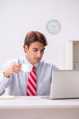 Ofiste çalışan çekici genç bir işadamı.  