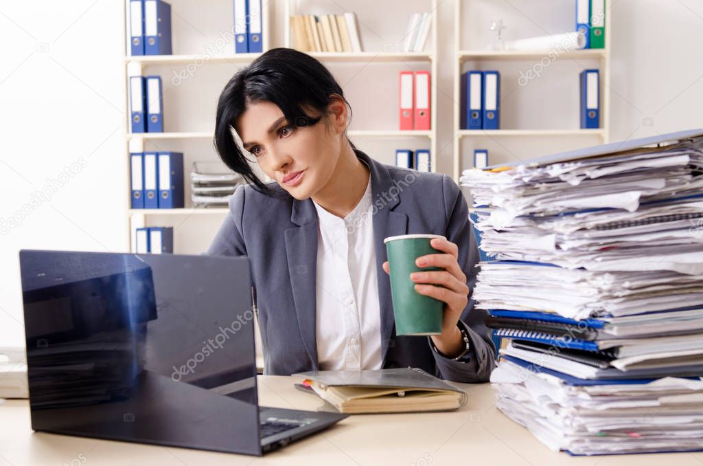 Middle aged businesslady unhappy with excessive work 