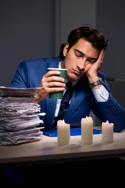 Businessman working late in office with candle light — Stock Photo, Image
