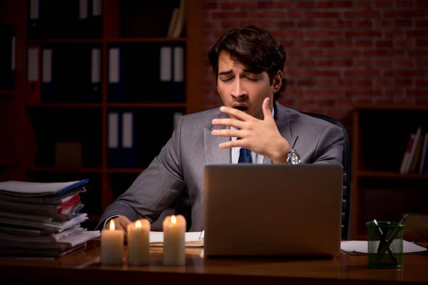 Businessman working late in office with candle light — Stock Photo, Image