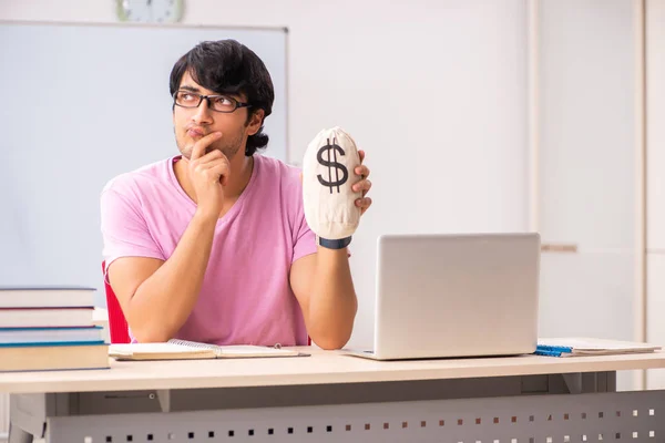Young male student sitting in the class — Stock Photo, Image