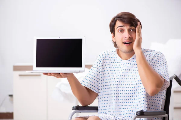 Young handsome man in wheelchair at the hospital — Stock Photo, Image