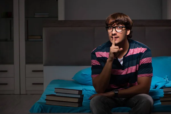 Joven estudiante guapo preparándose para los exámenes por la noche — Foto de Stock