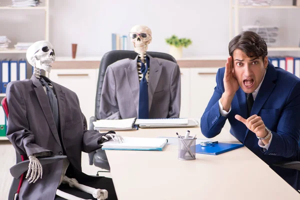 Funny business meeting with boss and skeletons — Stock Photo, Image