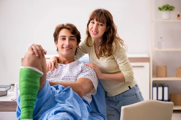 Loving wife looking after injured husband in hospital