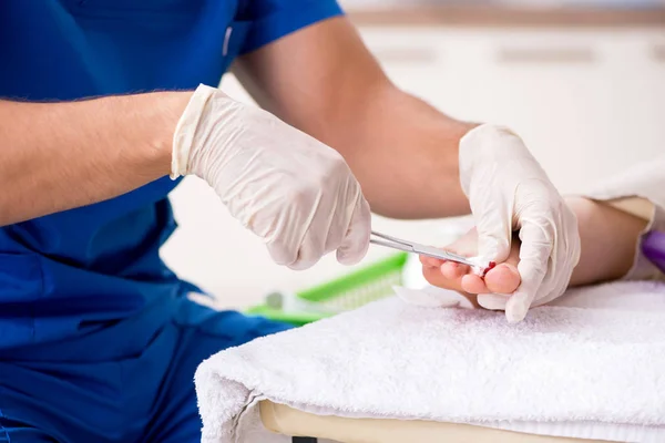 Podólogo tratando los pies durante el procedimiento — Foto de Stock